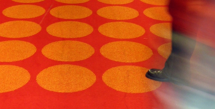Person walking on decorative carpet.