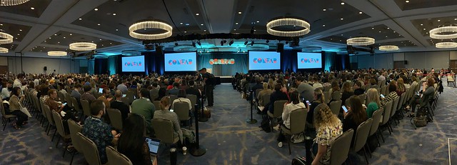 Panoramic of people in a large conference room for Confab 2019