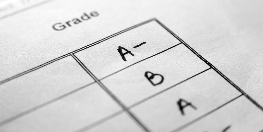 Grades listed on paper.