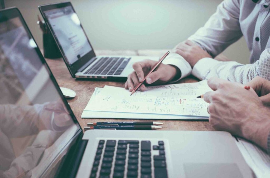 Two people reviewing content analytics data at a desk.