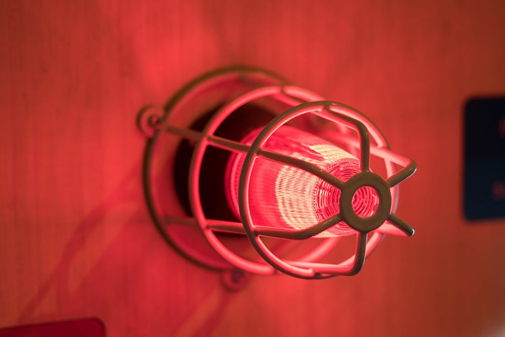 A lit up red alarm light.