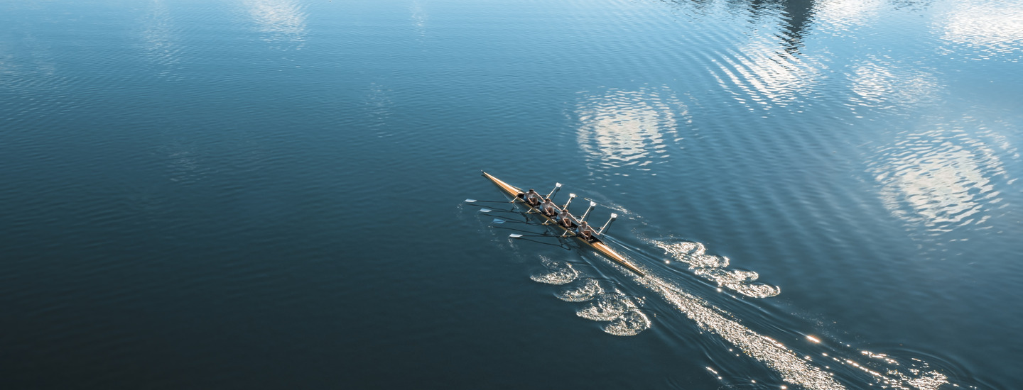 Rowing team on calm waters