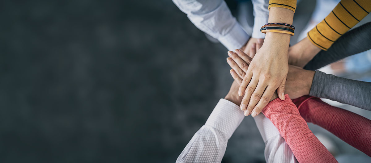 Hands together showing teamwork.