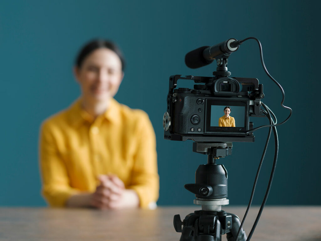 Woman in front of a camera.